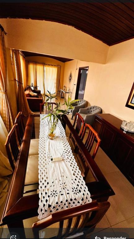 a dining room table with a white table cloth at Residencial Celedone in Boa Vista