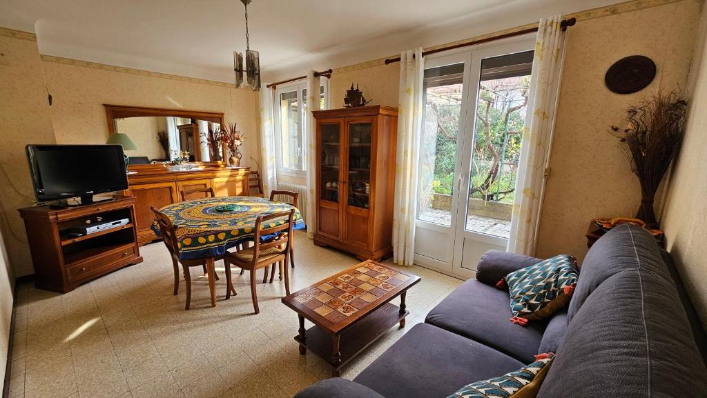 a living room with a couch and a table at Maison avec 3 chambres et jardin in Saint-Estève