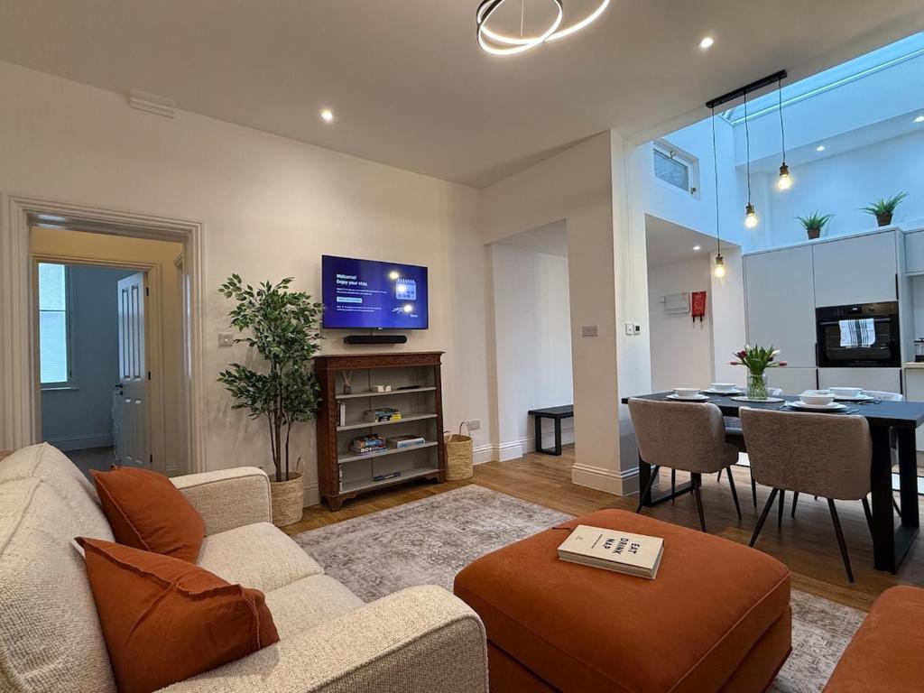 a living room with a couch and a dining room at Spacious, Worcester city centre 2 bedroom apartment in Worcester