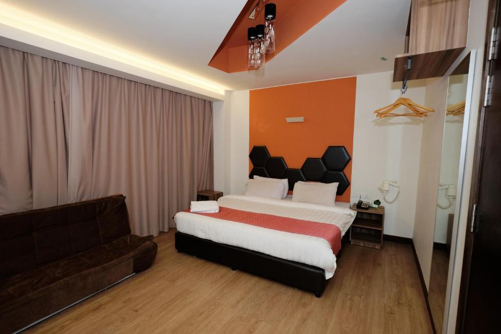 Postel nebo postele na pokoji v ubytování Memoire Hornbill Hotel Kuching Sarawak