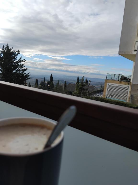 a cup of coffee sitting on a table in front of a window at La Barbacana in Laguardia
