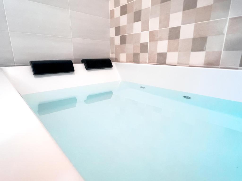 two toilets in a bathroom with two black seats at ISG Apartments Triana Jacuzzi 1 in Seville