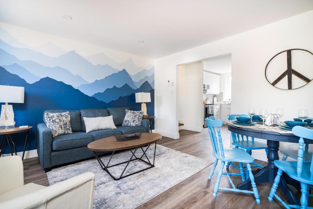 a living room with a mountain mural on the wall at "Hike" at Hills Meaford, Pet Friendly, 2BD Suite in Meaford
