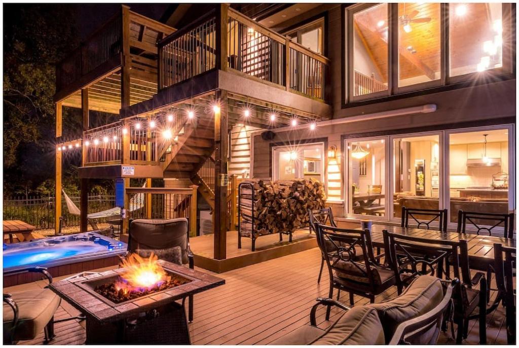a house with a fire pit in the middle of a patio at Elyon Hall Coach House in Gary