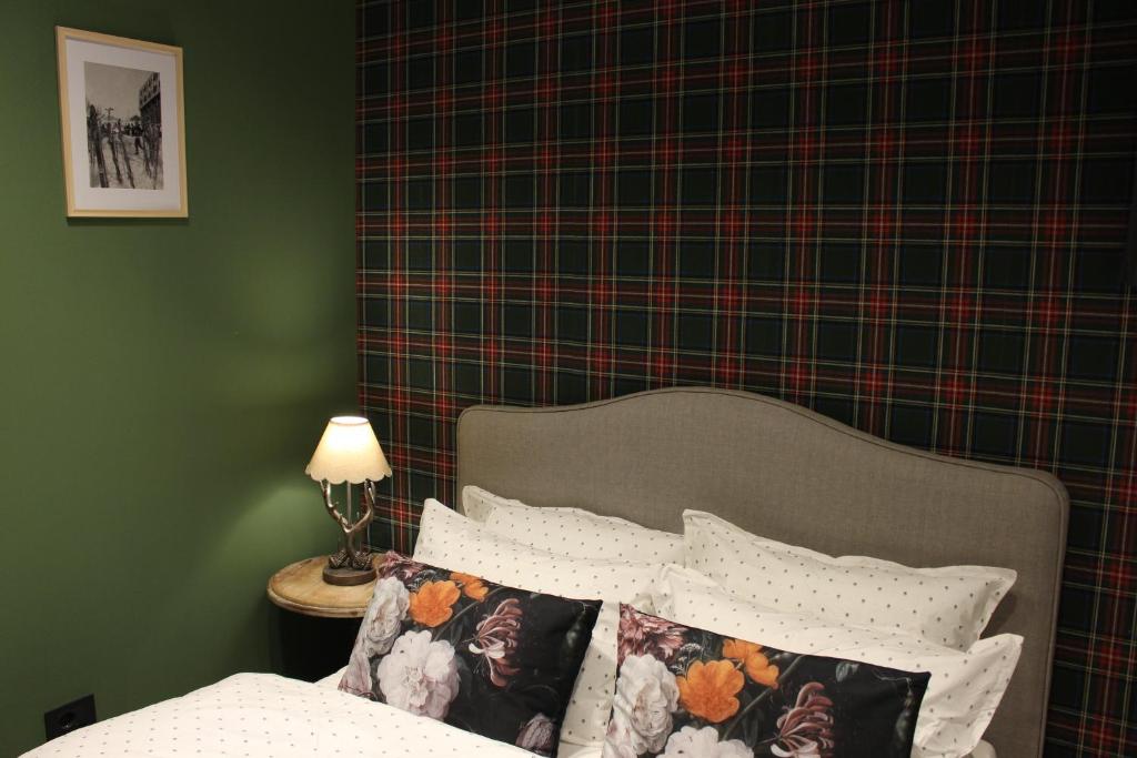 a bedroom with a bed with a plaid wall at Apartment25 Poljice Apart Hotel Jahorina in Jahorina
