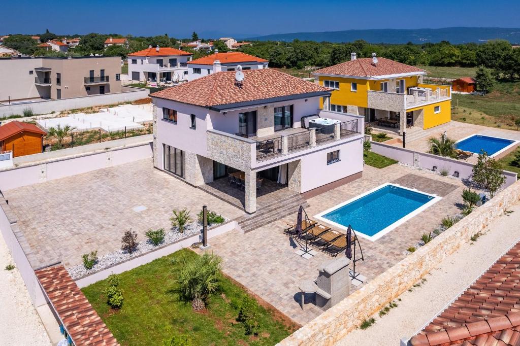 an aerial view of a house with a swimming pool at Ville Novak Villaggio by Adex Travel in Krnica