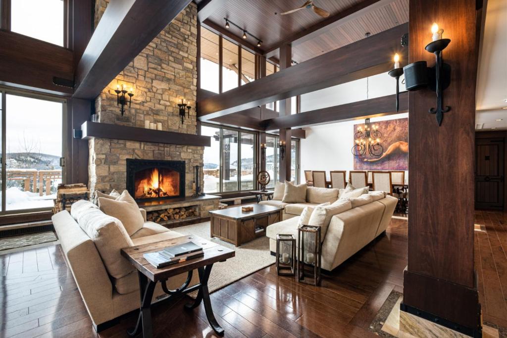 a living room with couches and a fireplace at Altitude 166-1 On the village 9bdr in Mont-Tremblant