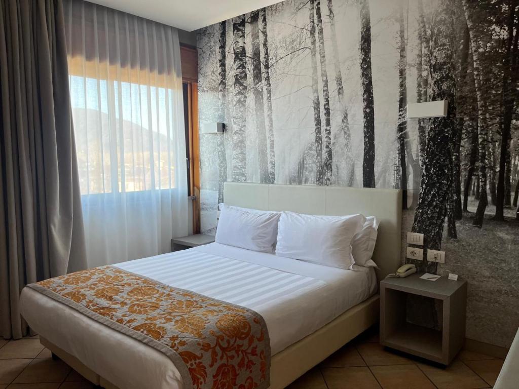 Łóżko lub łóżka w pokoju w obiekcie Hotel Napoleon