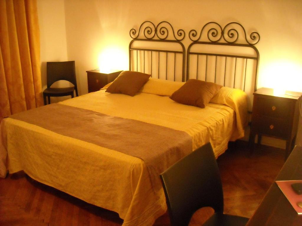 a bedroom with a large bed with a yellow blanket at B&B Sansevero Venice in Mestre