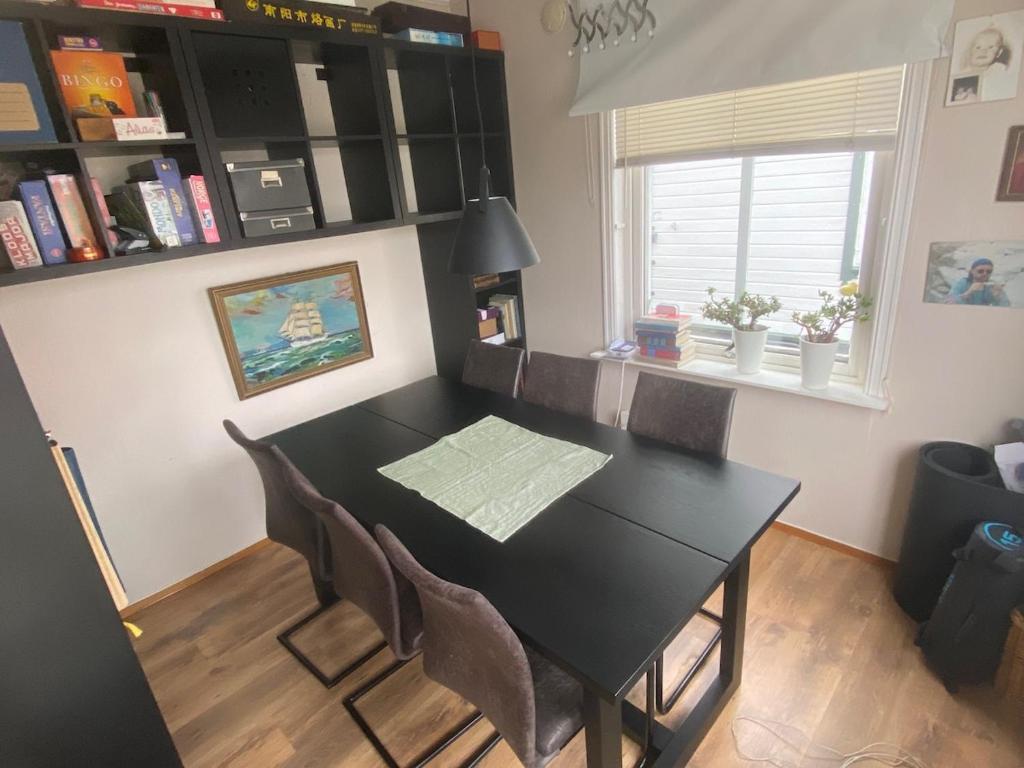 a dining room with a black table and chairs at 200 M TIL ALT to everything in Egersund