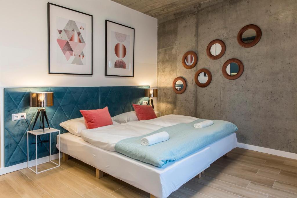 a bedroom with a large bed and mirrors on the wall at Piedmont House in Krakow