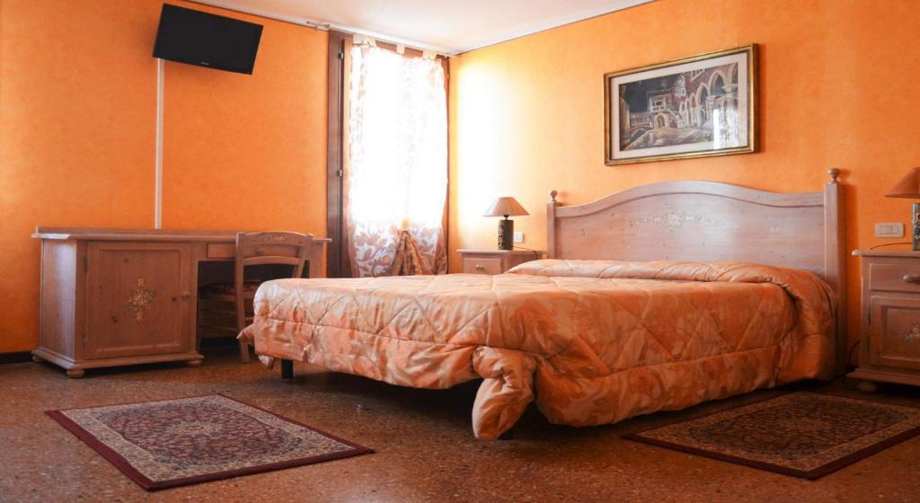 a bedroom with a bed and a table and a window at Best Holidays Venice in Venice