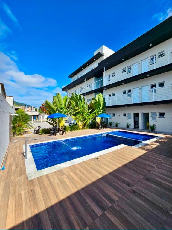 a swimming pool in front of a building at Chalés do Bona - Loft 14 in Ubatuba