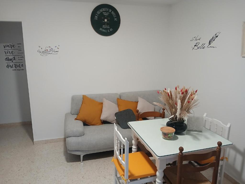 a living room with a couch and a table at Apartamentos de la mansión in Carmona