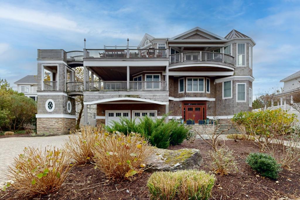 a large house with a balcony on top of it at The Chancellery --- 6 Hall Ave in Dewey Beach