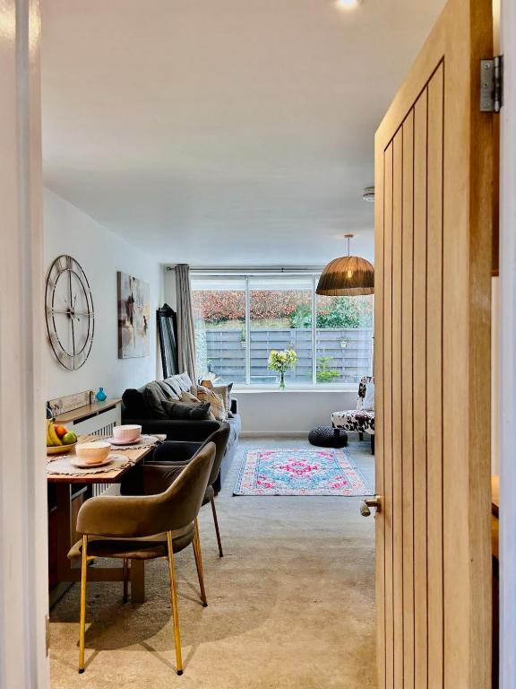 a living room with a couch and a table at The Old Post Office - MaisonPro in Stroud