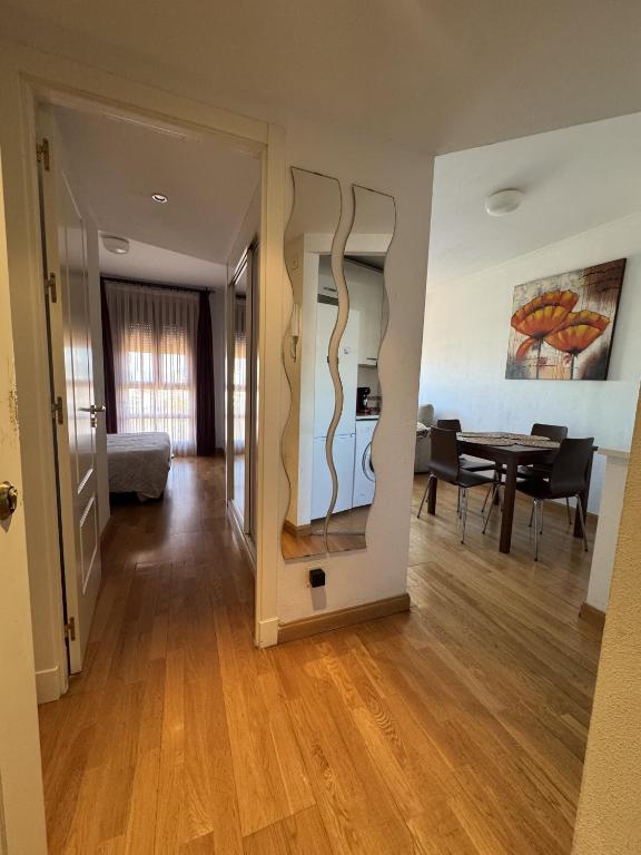 a hallway with a living room and a dining room at Casa con piscina in Madrid