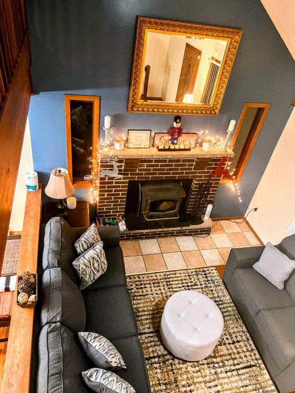 a living room with a couch and a fireplace at The CubHouse Poconos getaway in Tobyhanna