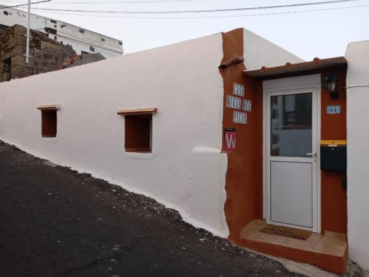 a white building with a door on the side of it at Casa de María del Pilar in Taibique