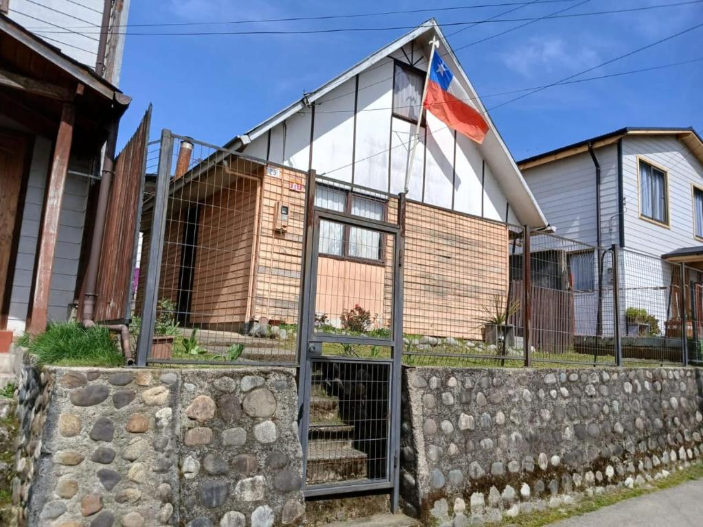 a house with a flag on top of it at CasaNancy in Panguipulli