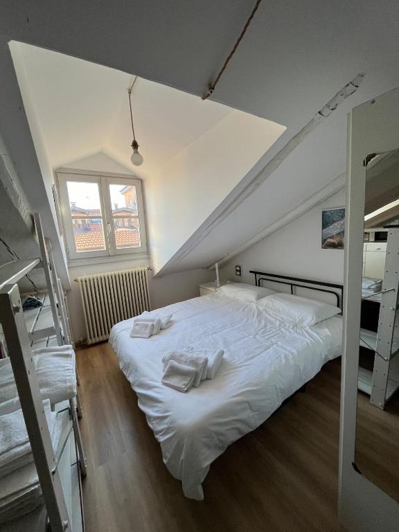 a bedroom with a large white bed in a attic at Pola's House Turin in Turin