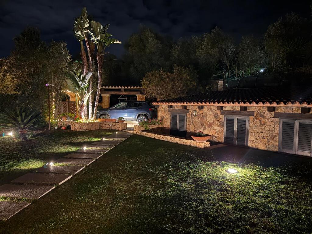 a house with a car parked in a yard at night at splendido open space in Villa Veronica Porto Istana in Porto Istana