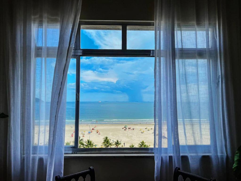 a view of a beach from a window at Vista Incrível para o MAR com 3 Quartos in São Vicente