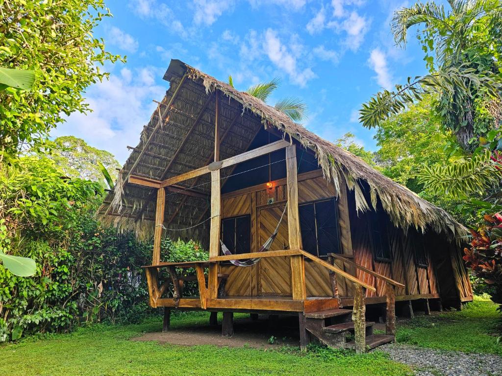 a small hut with a thatched roof at Wildlife Lodge Cahuita in Cahuita