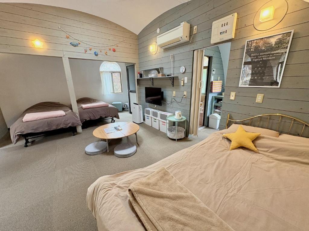 a bedroom with a bed and a tv in it at Seiryukyou in Nishinoomote