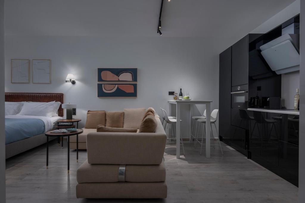 a living room with a bed and a couch and a table at Embassy Elegant Suite in Thessaloniki