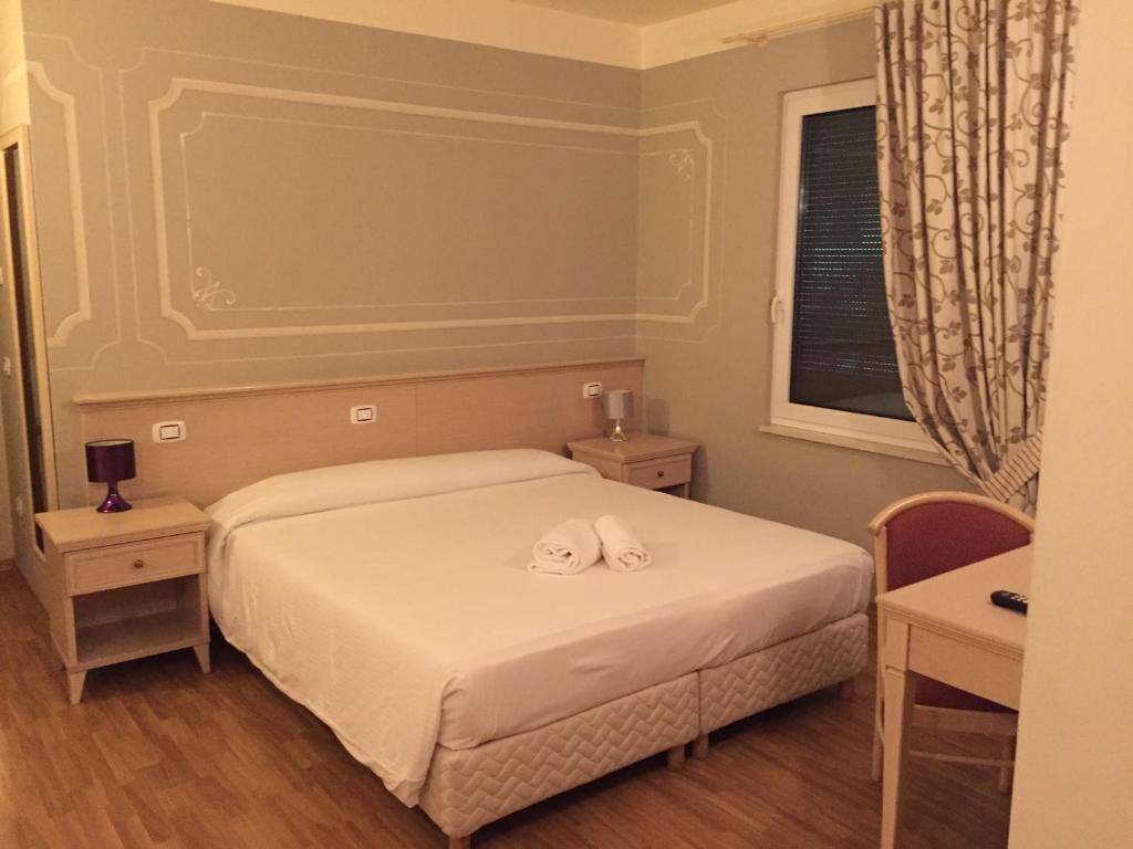 Postel nebo postele na pokoji v ubytování Albergo La Quiete