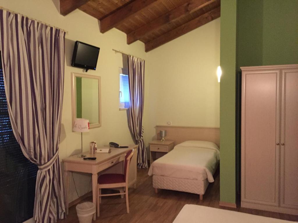 Postel nebo postele na pokoji v ubytování Albergo La Quiete
