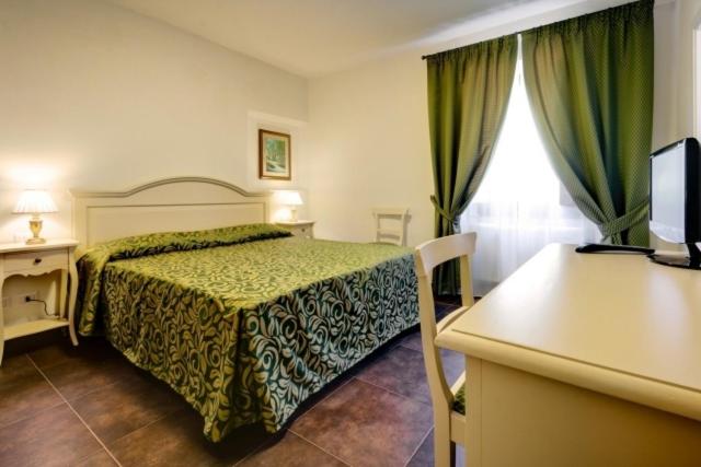 Postel nebo postele na pokoji v ubytování Hotel Il Cavallo