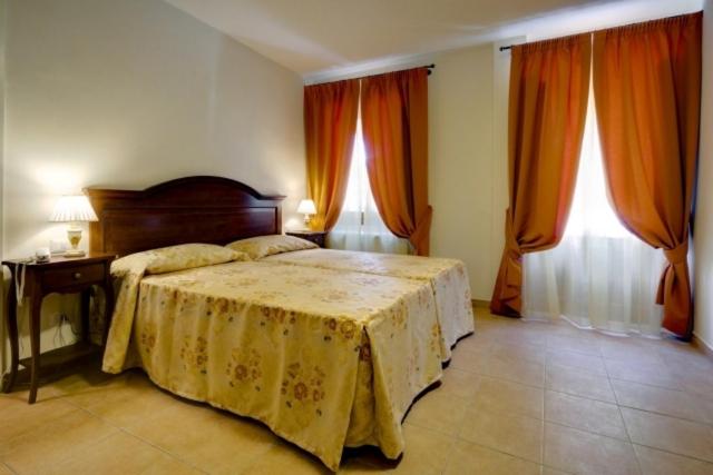 Postel nebo postele na pokoji v ubytování Hotel Il Cavallo