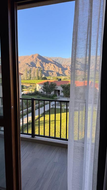 a view from a window with a view of a field at Vista Montañas y Viñas in Cafayate