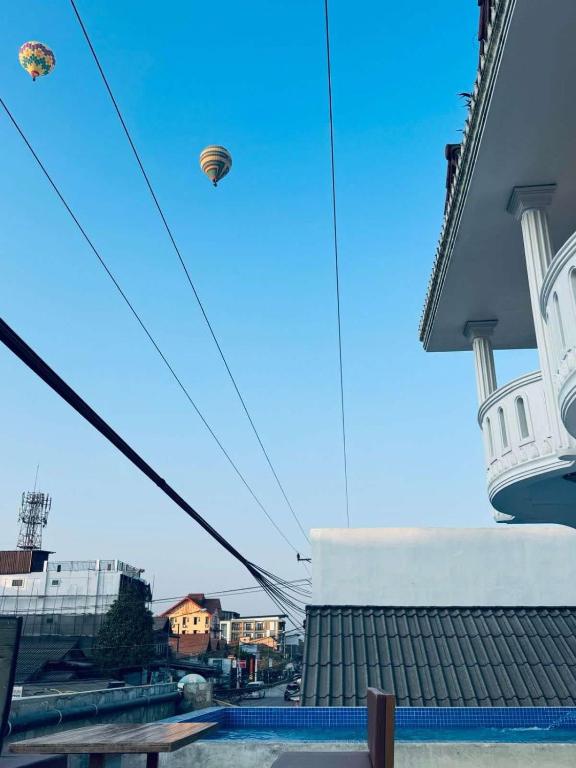 a kite flying in the sky above a building at Vang Vieng Rivercube Hotel in Vang Vieng