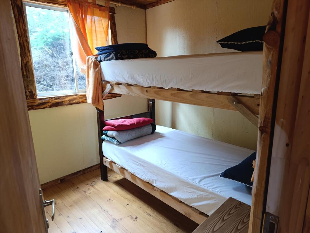 Postel nebo postele na pokoji v ubytování Cabañas Rustikas