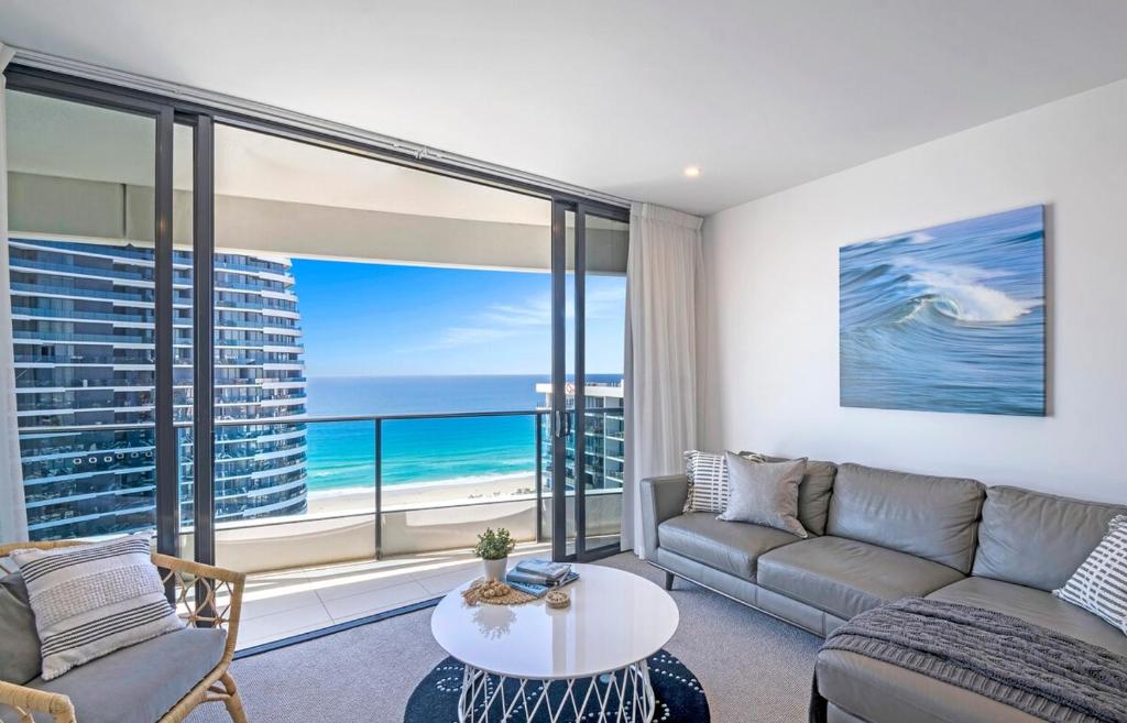 a living room with a couch and a table at MEGA VIEWS at Oracle - level 32 in Gold Coast