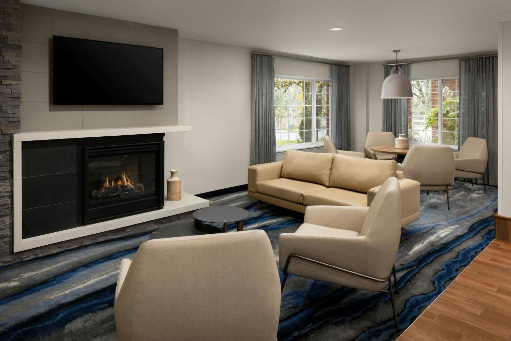 a living room with a couch and a fireplace at Fairfield Inn & Suites Portland South/Lake Oswego in Lake Oswego