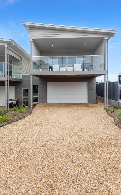 an empty driveway in front of a house at Modern Beachhouse, sea views in McCracken