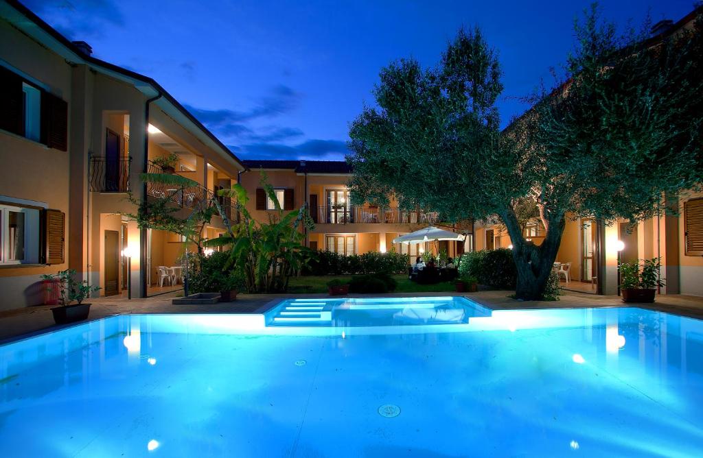 a swimming pool in front of a building at night at Residence Villa Andrea in Marina di Camerota