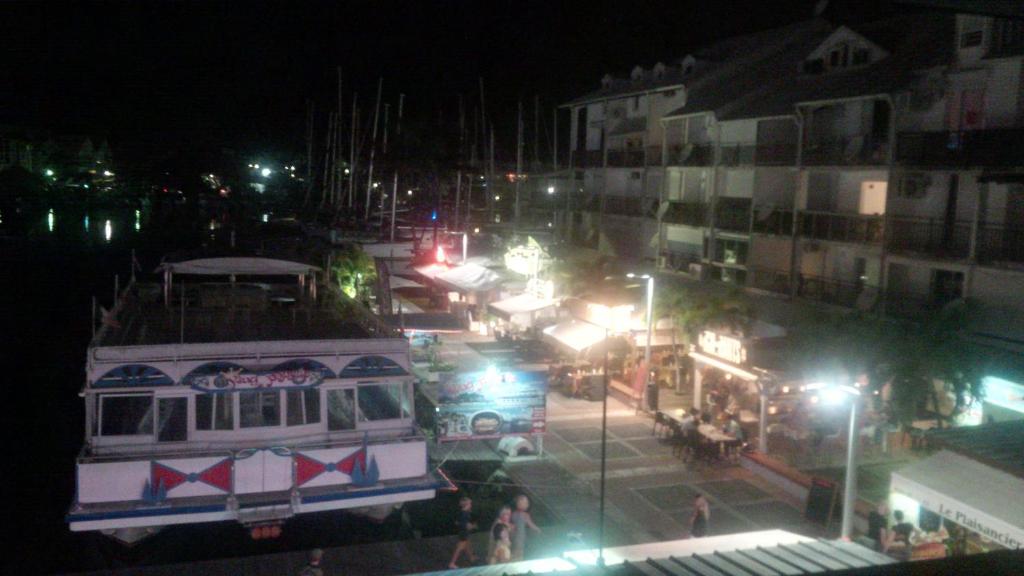 a city street at night with a trolley at Joli Studio Vue Sur Mer in Pointe-à-Pitre