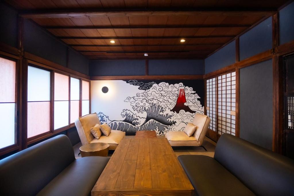 a dining room with a wooden table and chairs at NATAN - 7mins walk from Kawaguchiko Station in Fujikawaguchiko