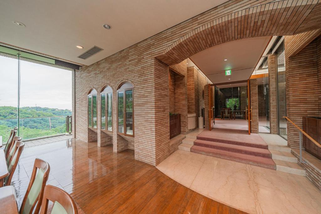 a large room with a brick wall and a fireplace at 熱海山荘 in Atami
