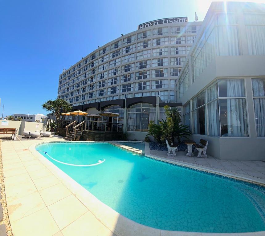 a large swimming pool in front of a building at Hotel Osner in East London