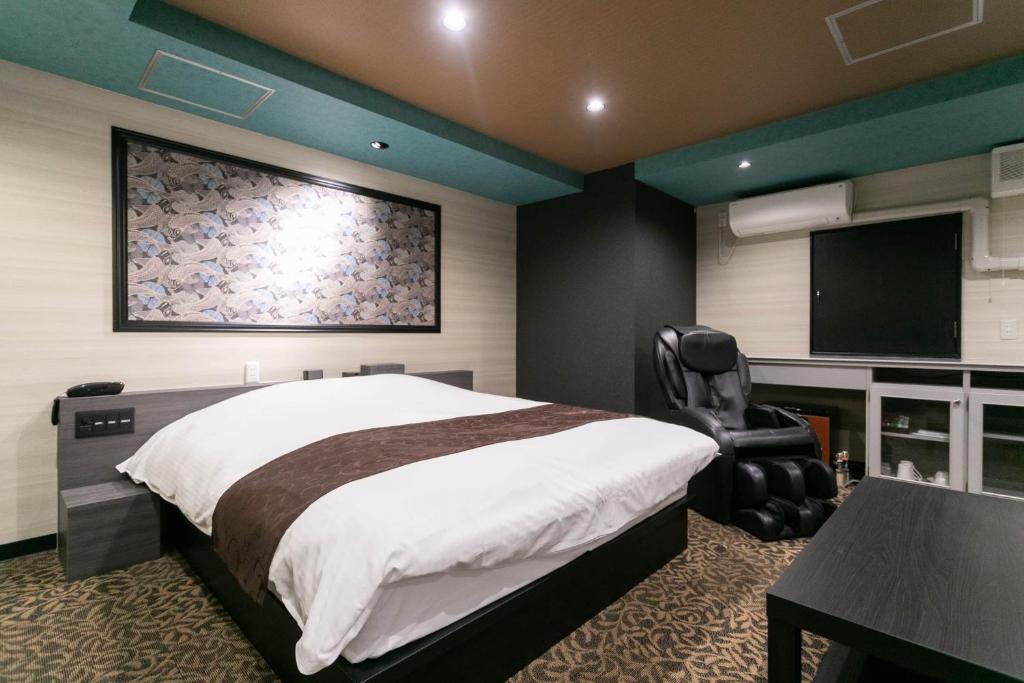 Postel nebo postele na pokoji v ubytování Hotel TEMARI Matsumoto