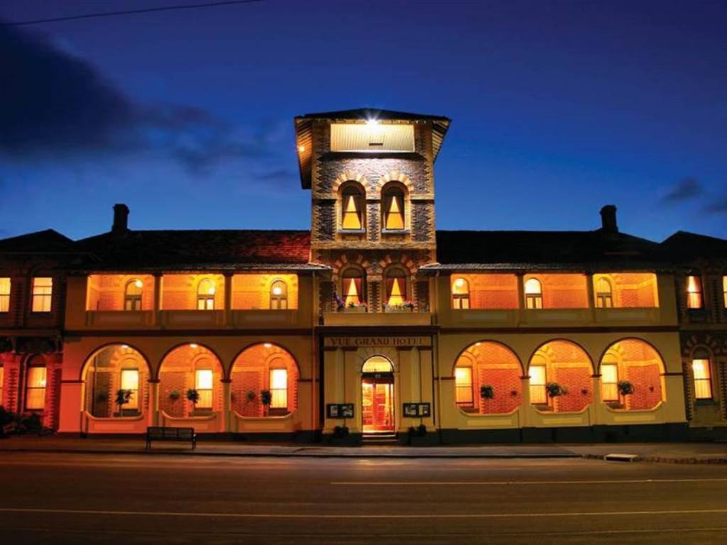 a building with a tower on top of it at night at Vue Grand Hotel in Queenscliff