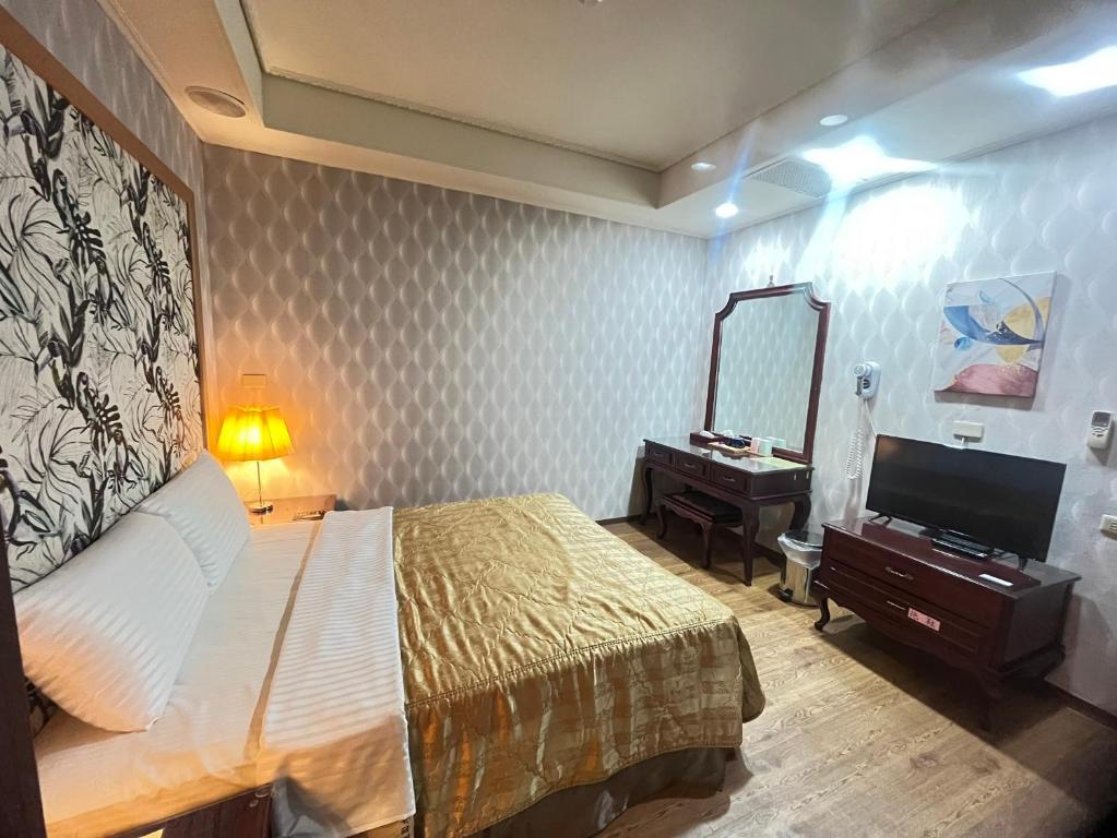 Voodi või voodid majutusasutuse Garden Business Hotel toas