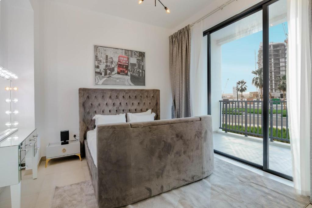 a bedroom with a large bed and a large window at RAKvista Residence in Ras al Khaimah