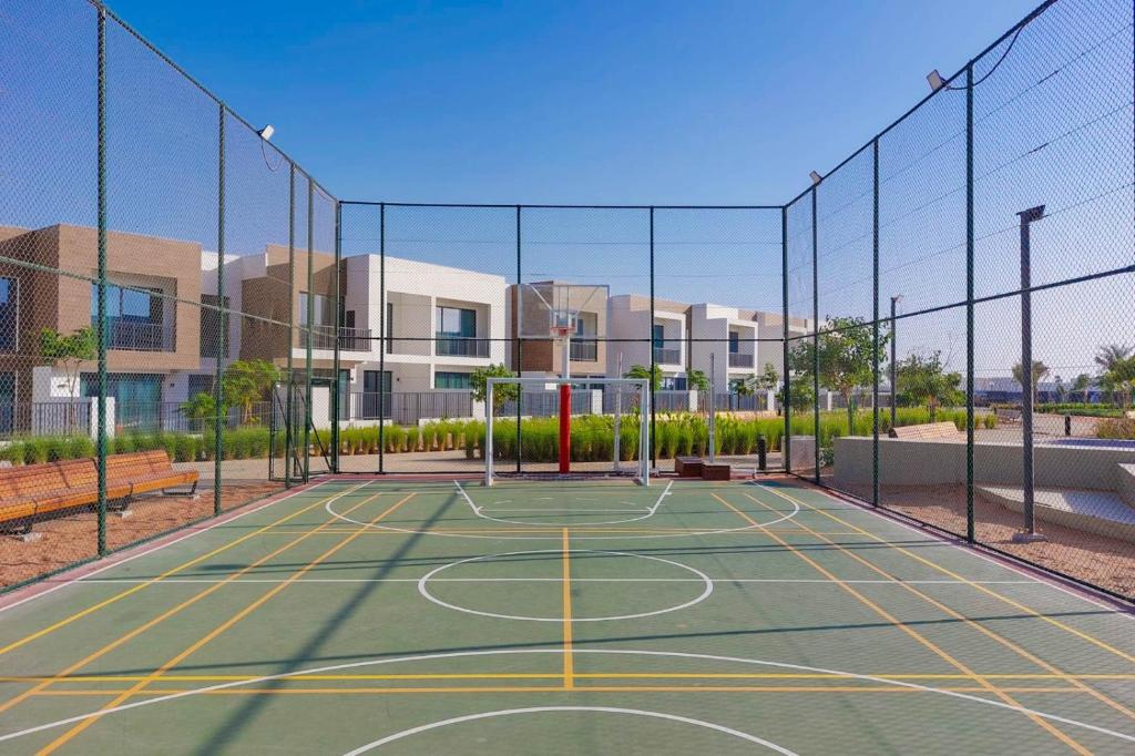 a tennis court with a net on top of it at RAKvista Residence in Ras al Khaimah